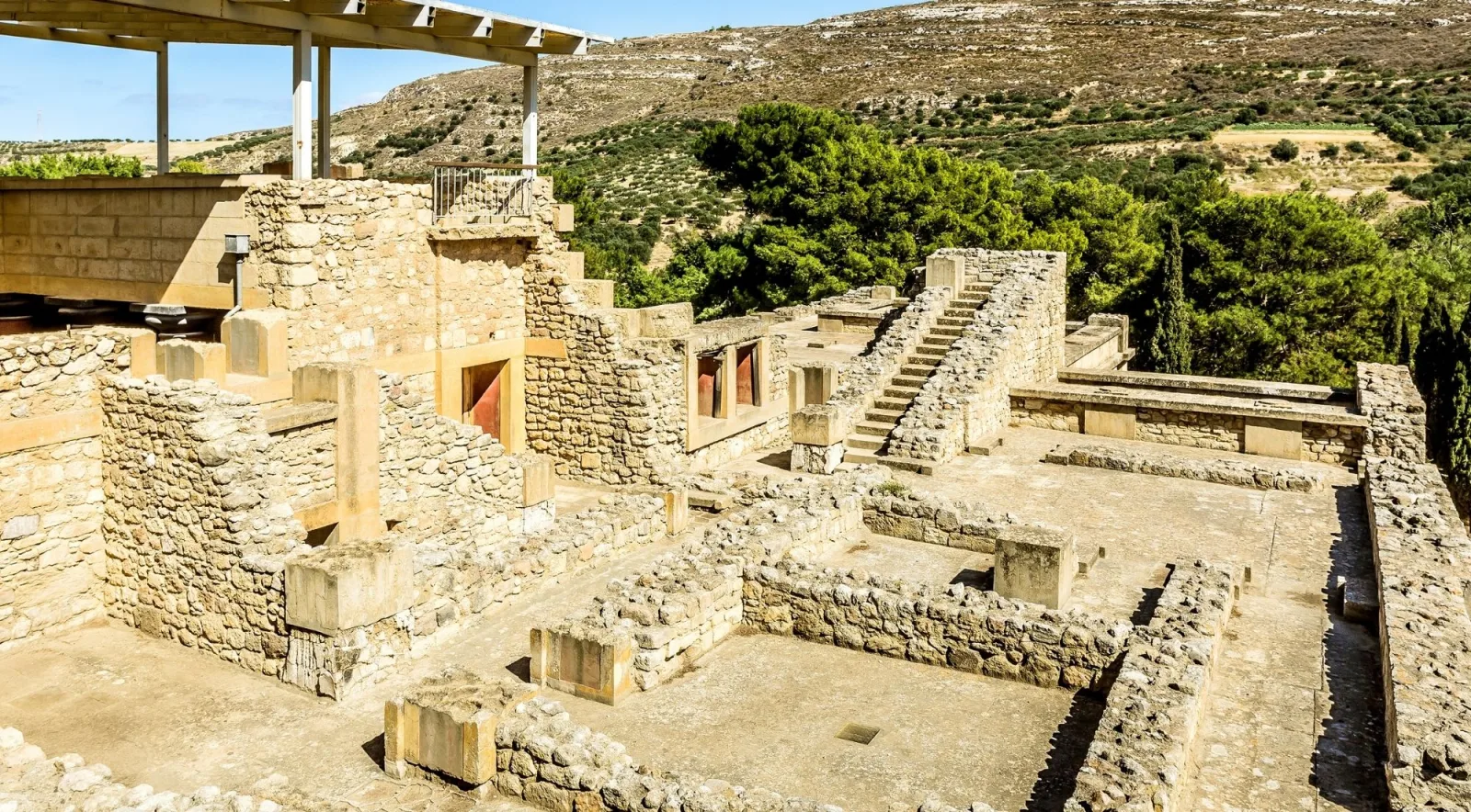 Elevated view over the stone foundations of Knossos towards the surrounding Cretan hills
