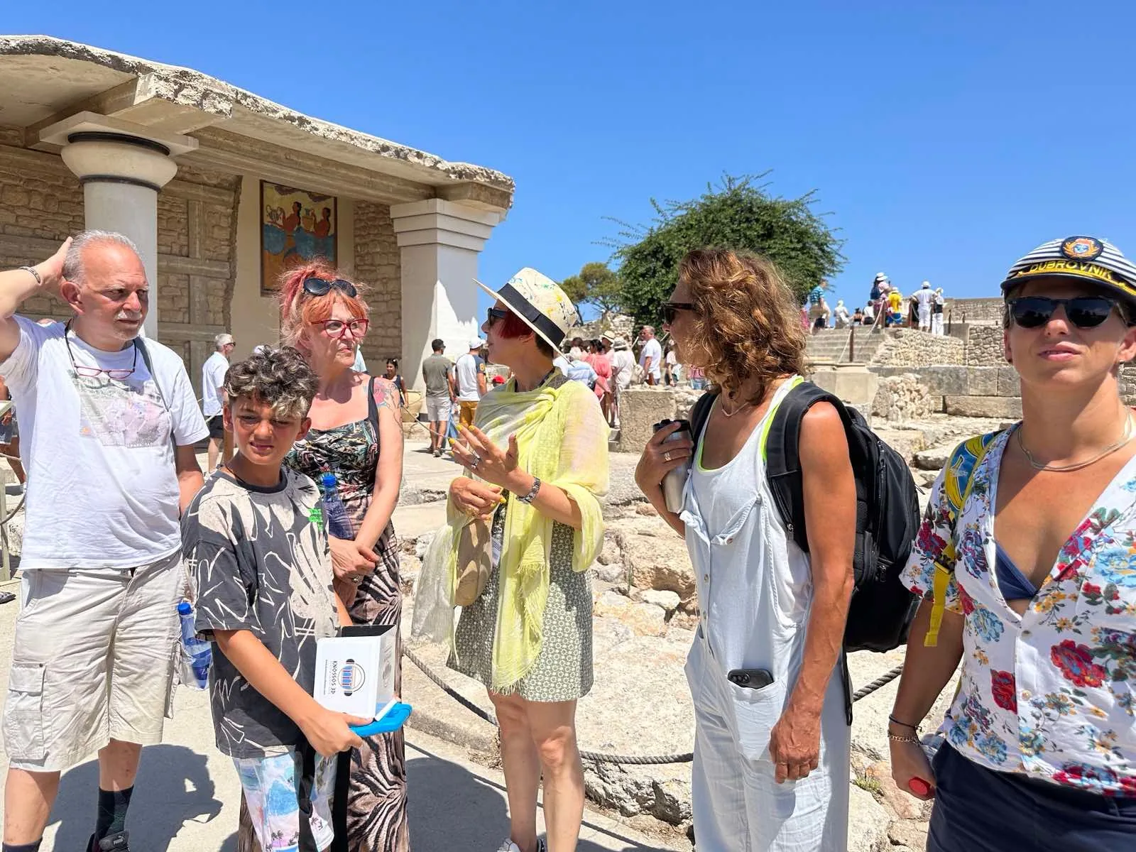 Visitors and guides on the raised walkway above the excavated ruins at Knossos