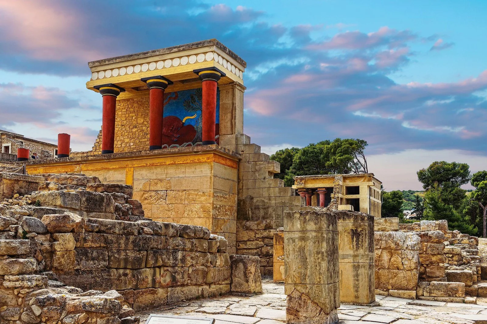 The restored North Entrance of Knossos with red columns and the charging-bull fresco