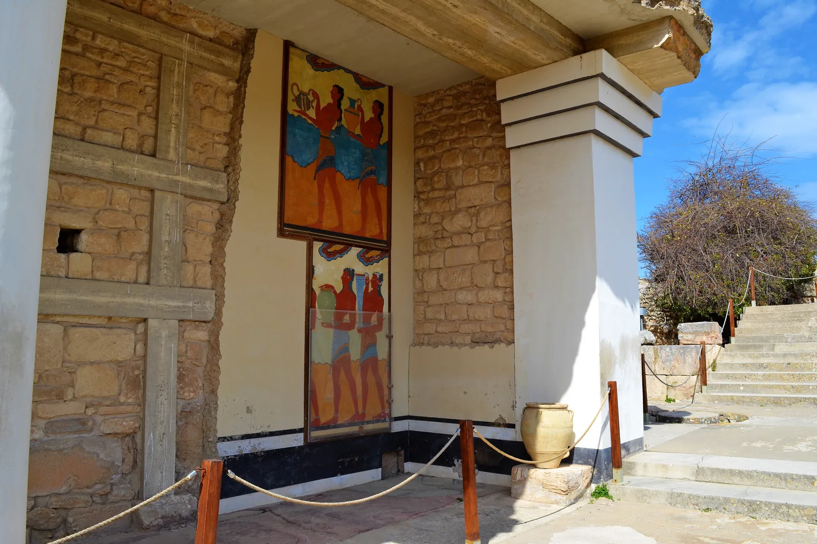 A reproduction of the Minoan Procession fresco beside a restored doorway at Knossos