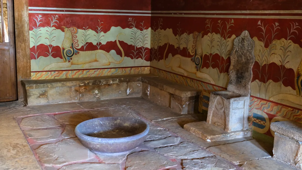 The Throne Room at Knossos, stone throne and lustral basin beneath red griffin frescoes